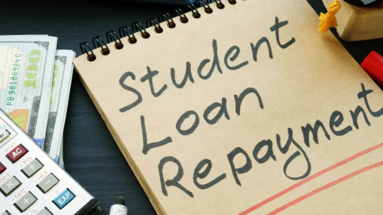Close up on a plate of mashed potatoes, topped with baked pork chops with cream of mushroom soup, and a side of green beans.